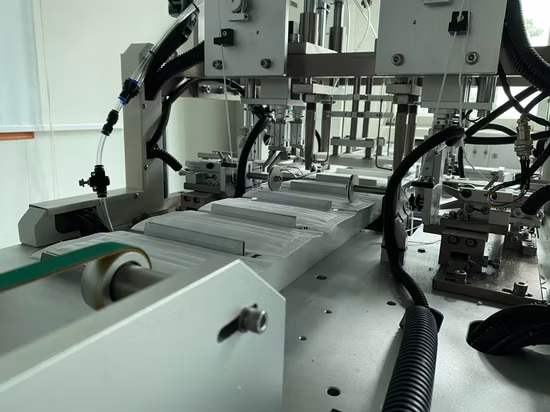 Automatische Maschine zur Herstellung flacher Gesichtsmasken mit einem Antrieb und zwei